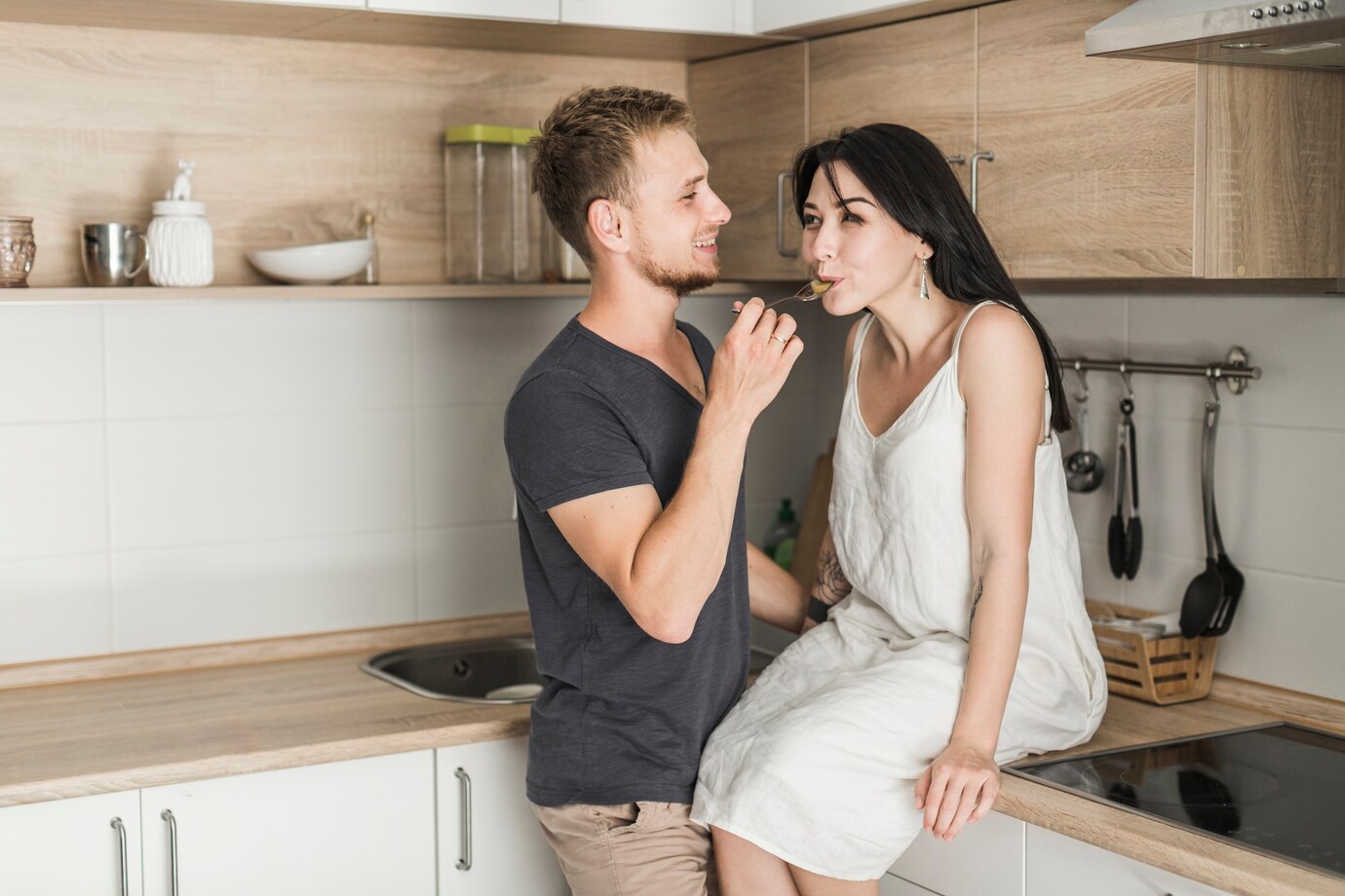 Smiling husband feeding food to his wife